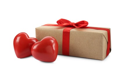 Photo of Beautiful gift box with red bow and decorative hearts on white background