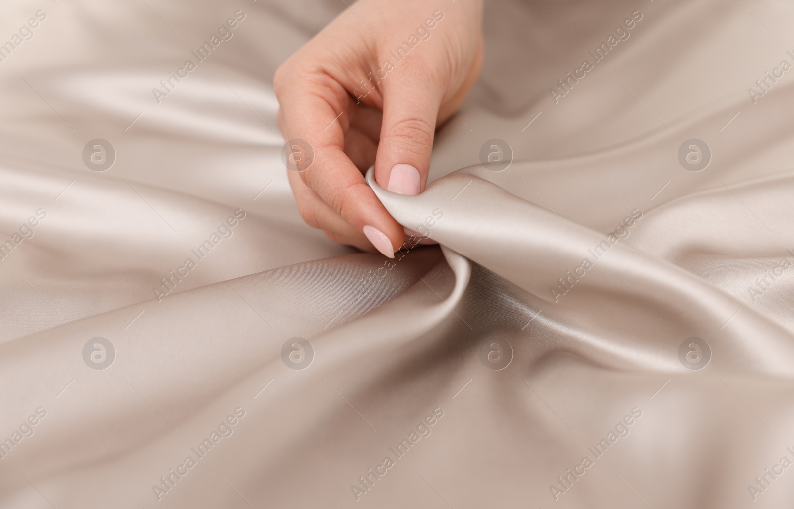 Photo of Woman touching smooth silky fabric, closeup view