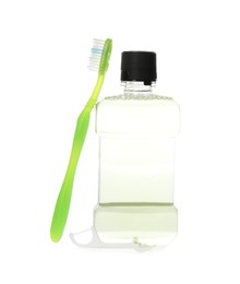 Photo of Bottle with mouthwash and toothbrush on white background