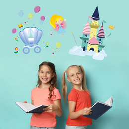 Image of Happy girls reading books on light blue background