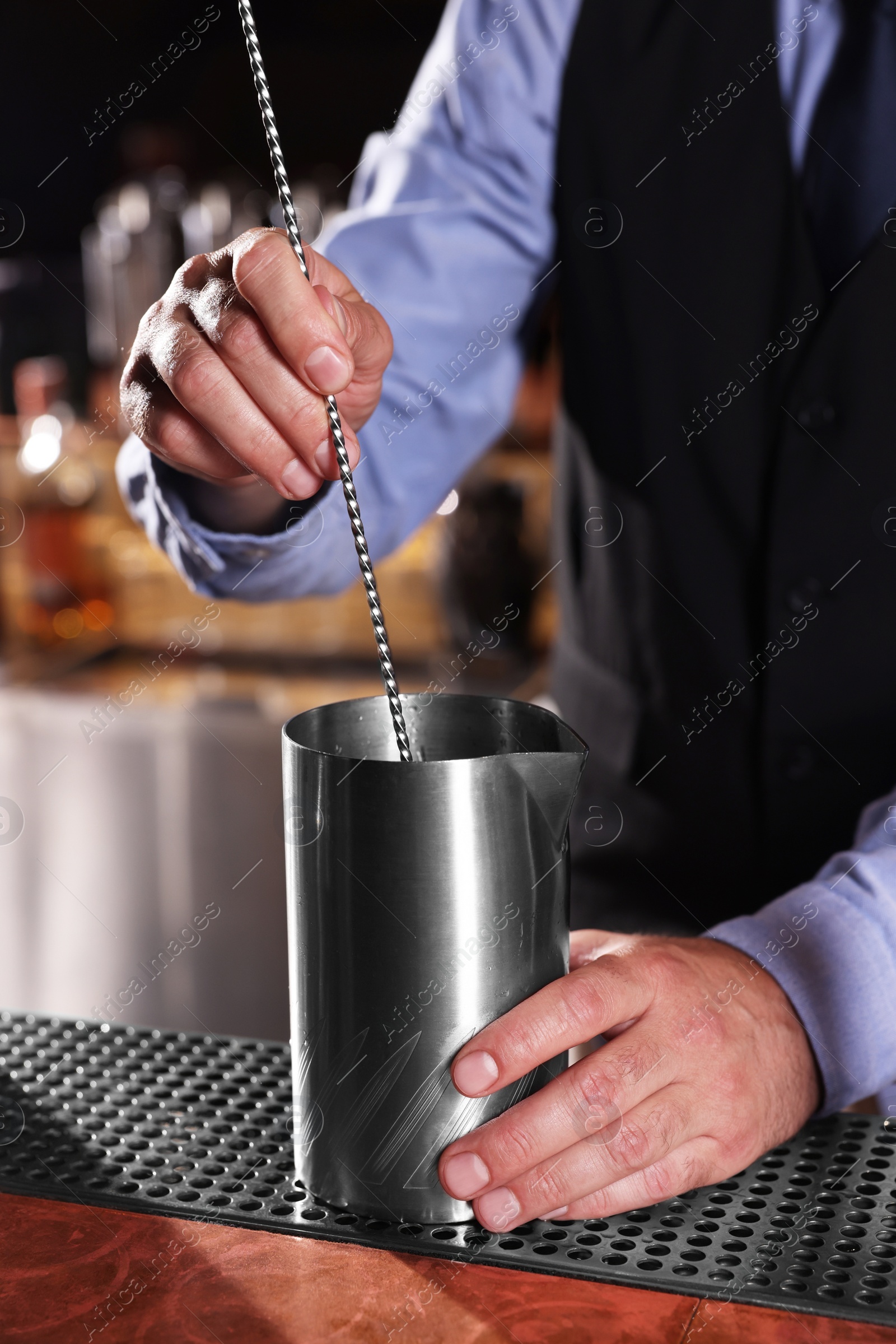 Photo of Bartender preparing fresh alcoholic cocktail in bar, closeup