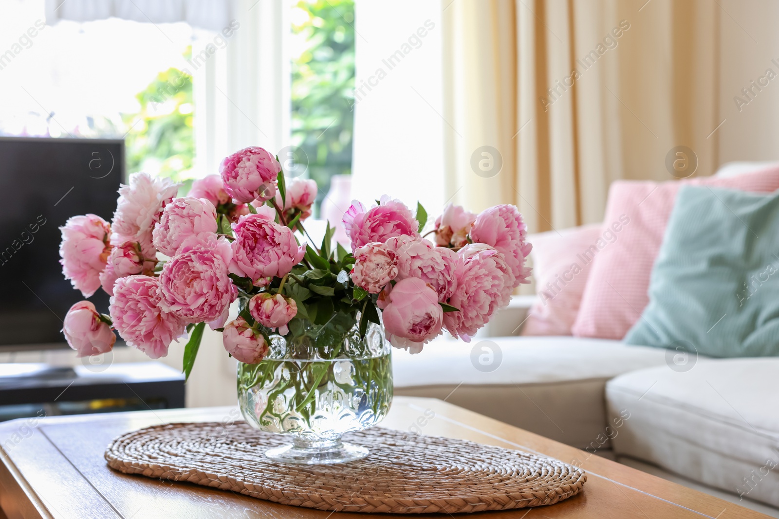 Photo of Beautiful pink peonies in vase on table at home, space for text. Interior design