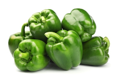 Pile of tasty green bell peppers on white background