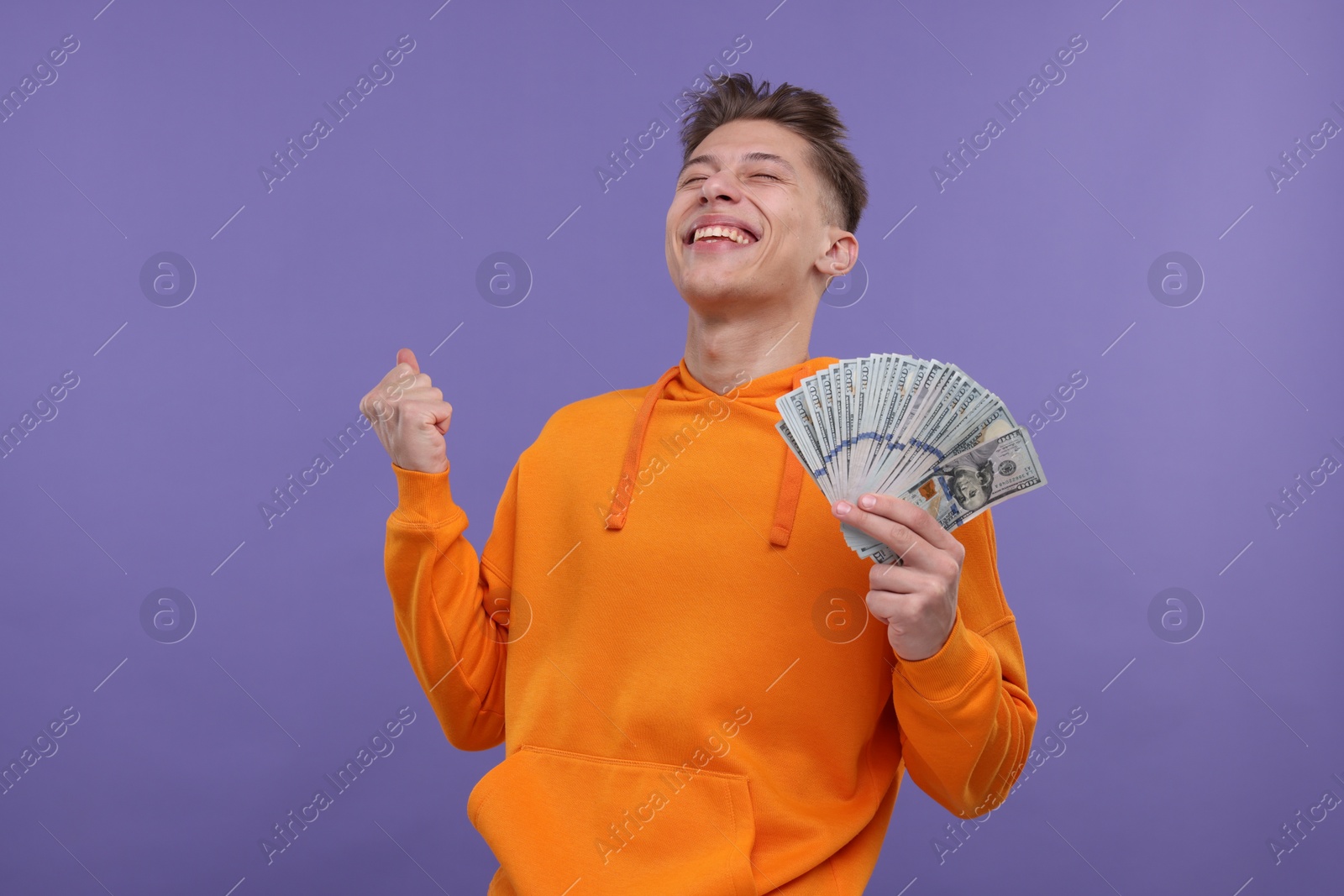 Photo of Happy man with money on purple background