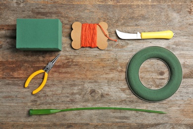 Photo of Florist equipment on wooden background, top view