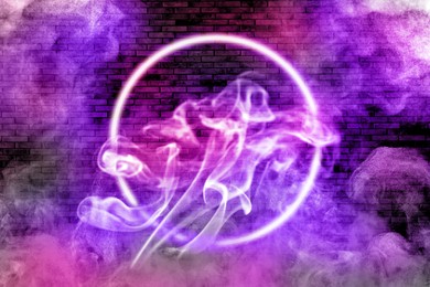 Neon frame in smoke against brick wall