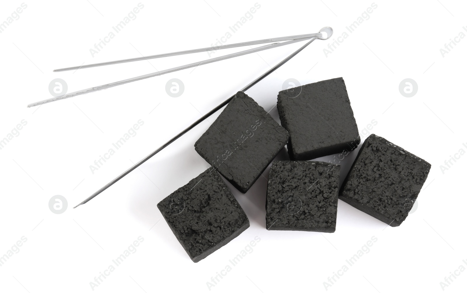 Photo of Charcoal cubes for hookah and tongs on white background, top view