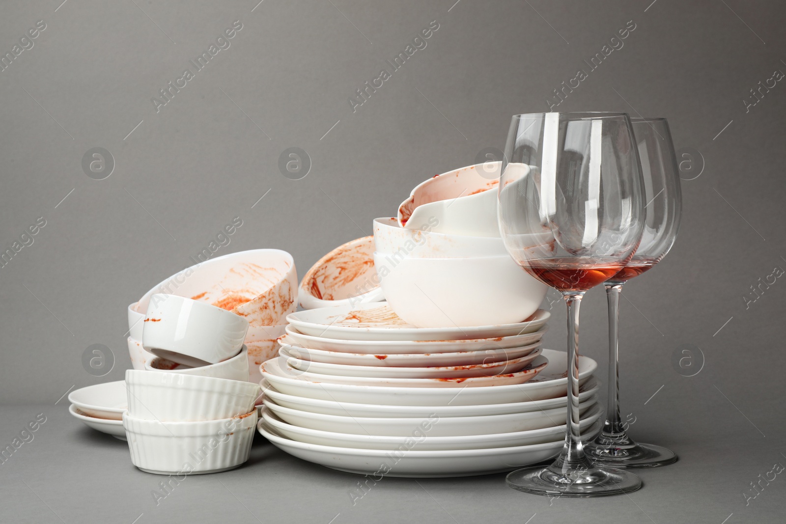 Photo of Set of dirty dishes on grey background