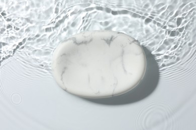 Photo of Presentation for product. Marble podium in water on white background, top view