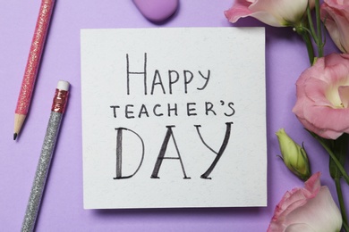 Flat lay composition with words HAPPY TEACHER'S DAY, stationery and flowers on violet background