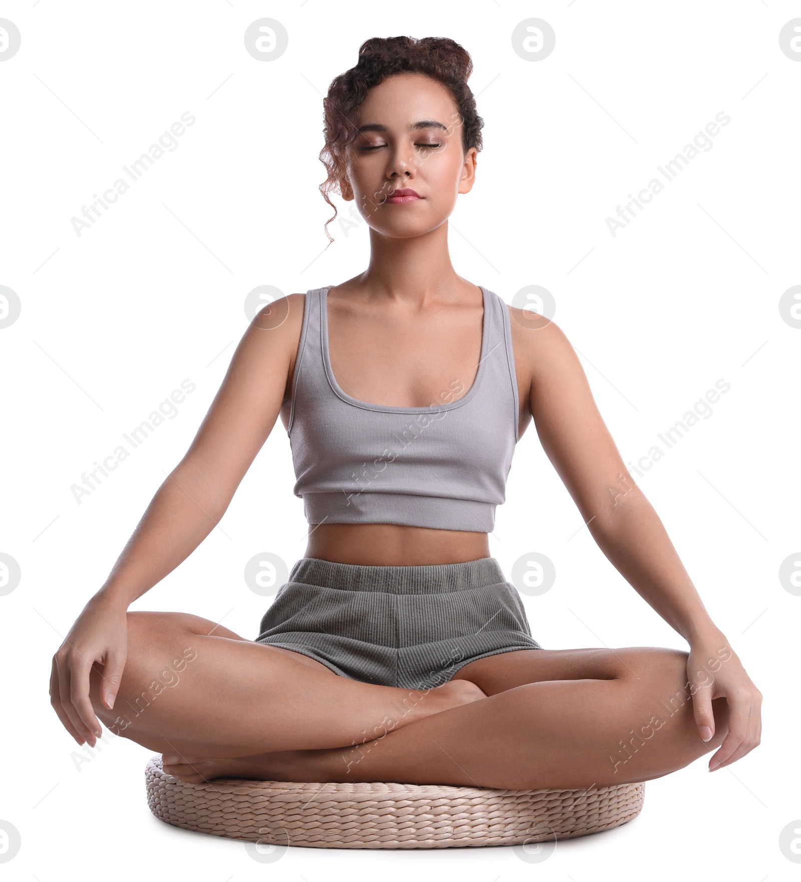 Photo of Beautiful African-American woman meditating on white background