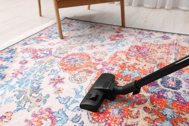 Hoovering carpet with vacuum cleaner indoors, space for text