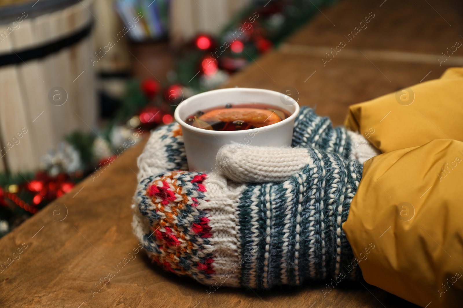 Photo of Woman with cup of mulled wine at counter, closeup