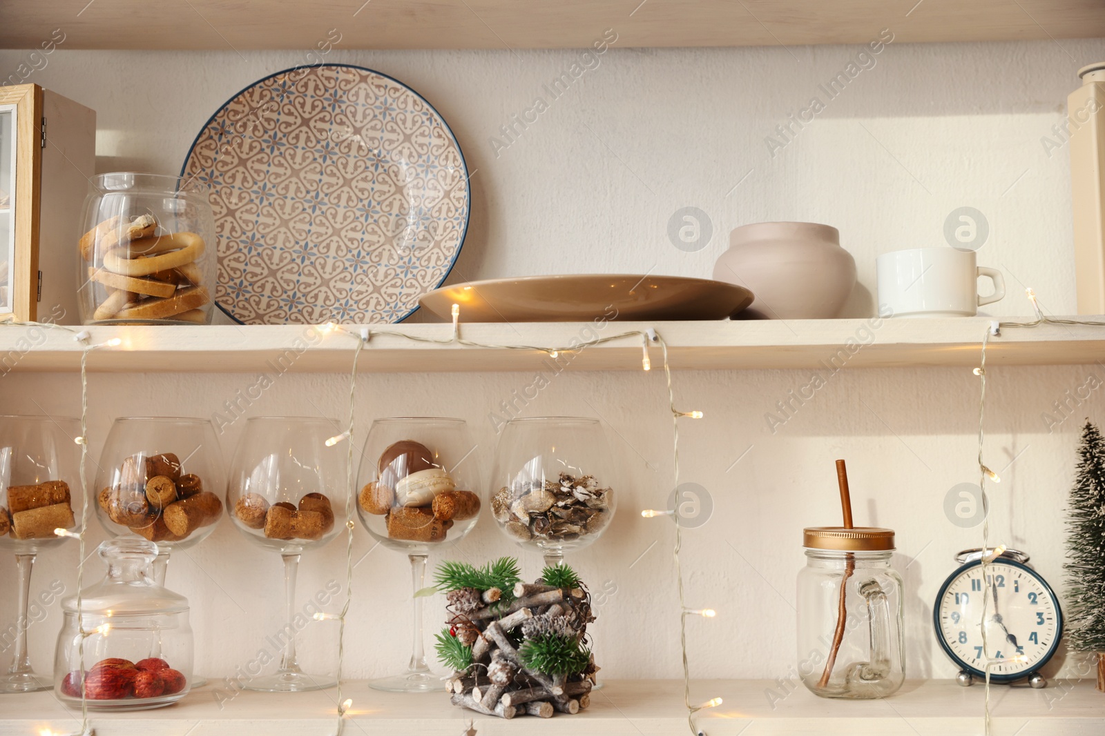 Photo of Shelving unit with kitchenware and Christmas decor