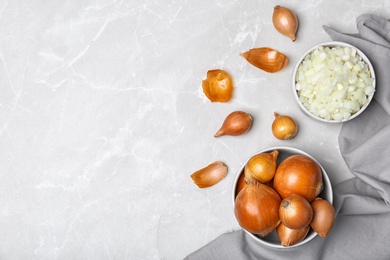 Flat lay composition with fresh ripe onions on table