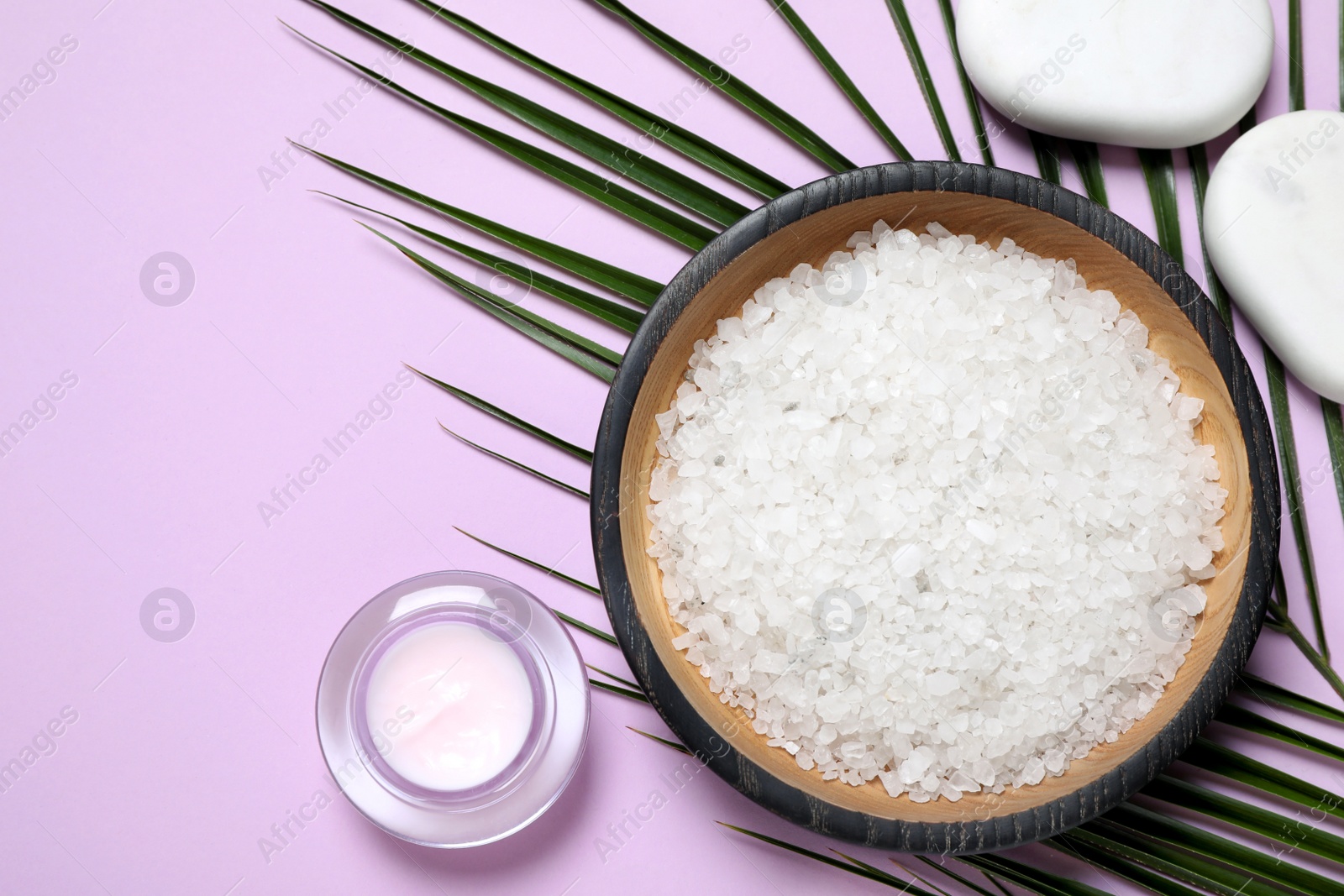 Photo of Flat lay composition with white sea salt on lilac background