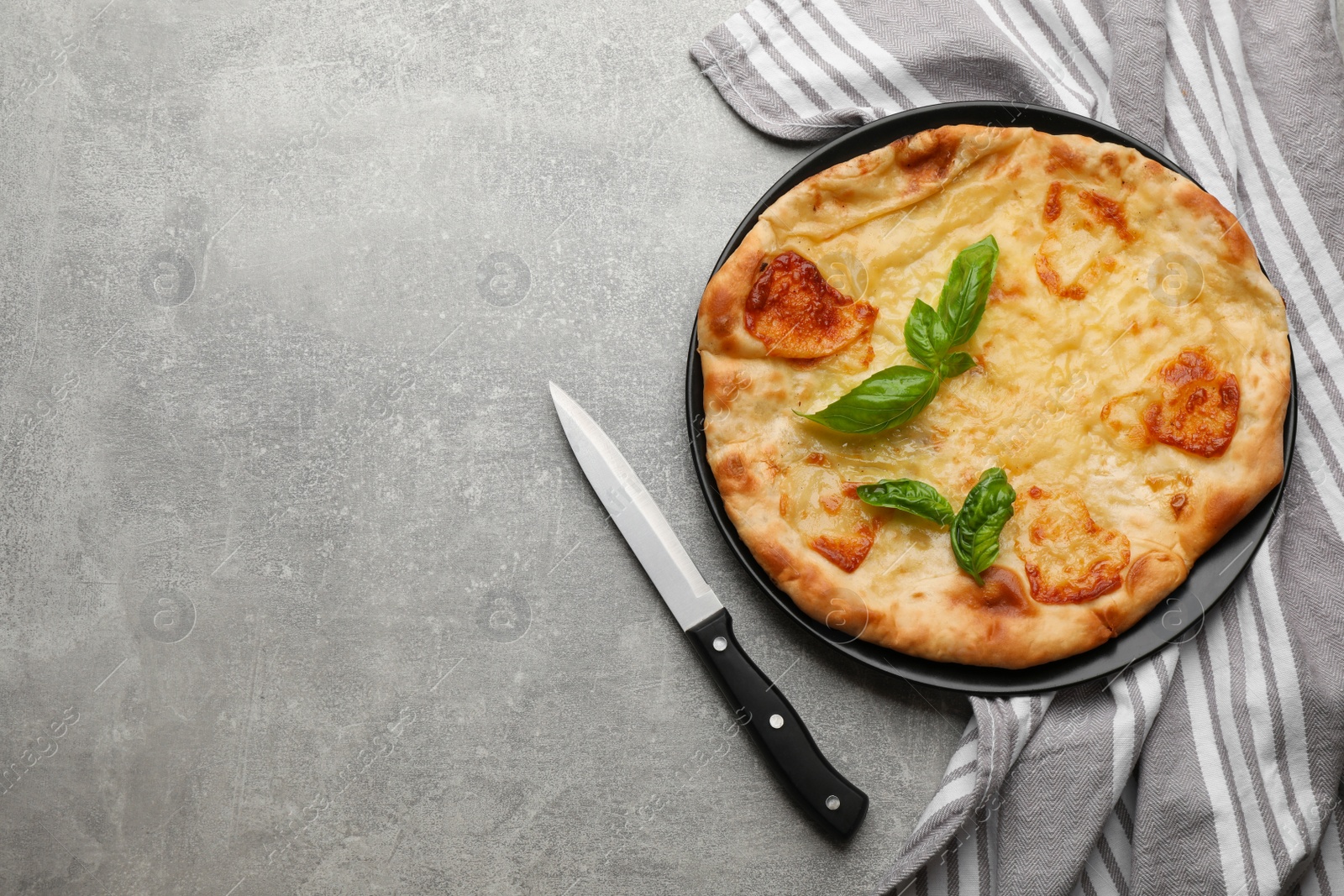 Photo of Delicious khachapuri with cheese on grey table, flat lay. Space for text