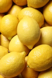 Photo of Fresh lemons as background, closeup. Citrus fruit