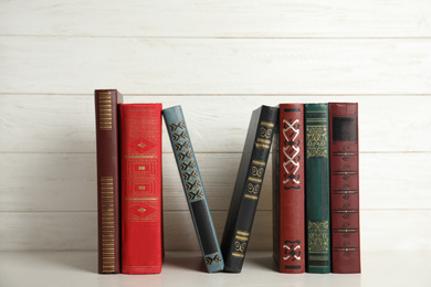 Photo of Collection of old books on white shelf