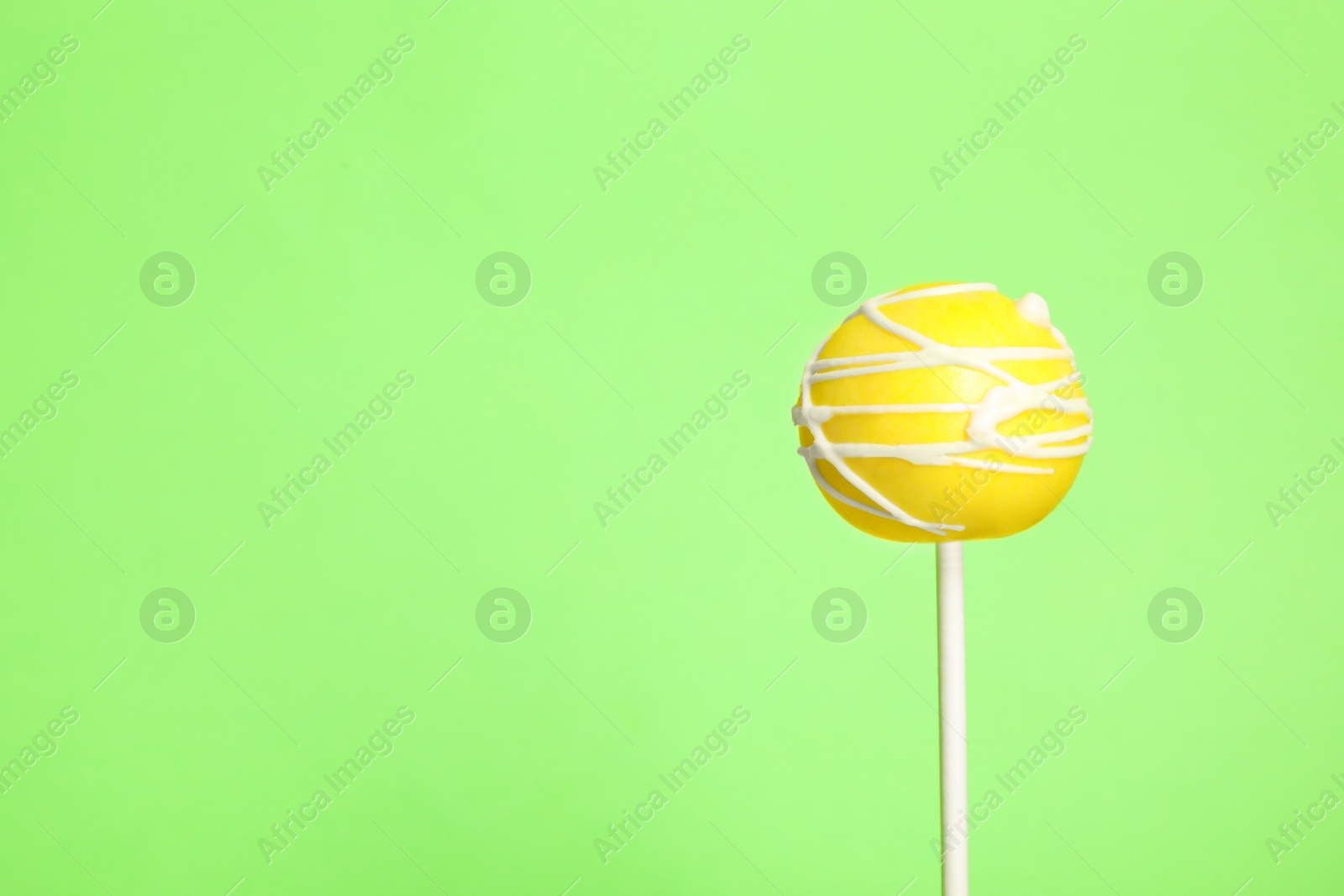 Photo of Bright delicious cake pop on color background. Space for text