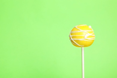 Bright delicious cake pop on color background. Space for text