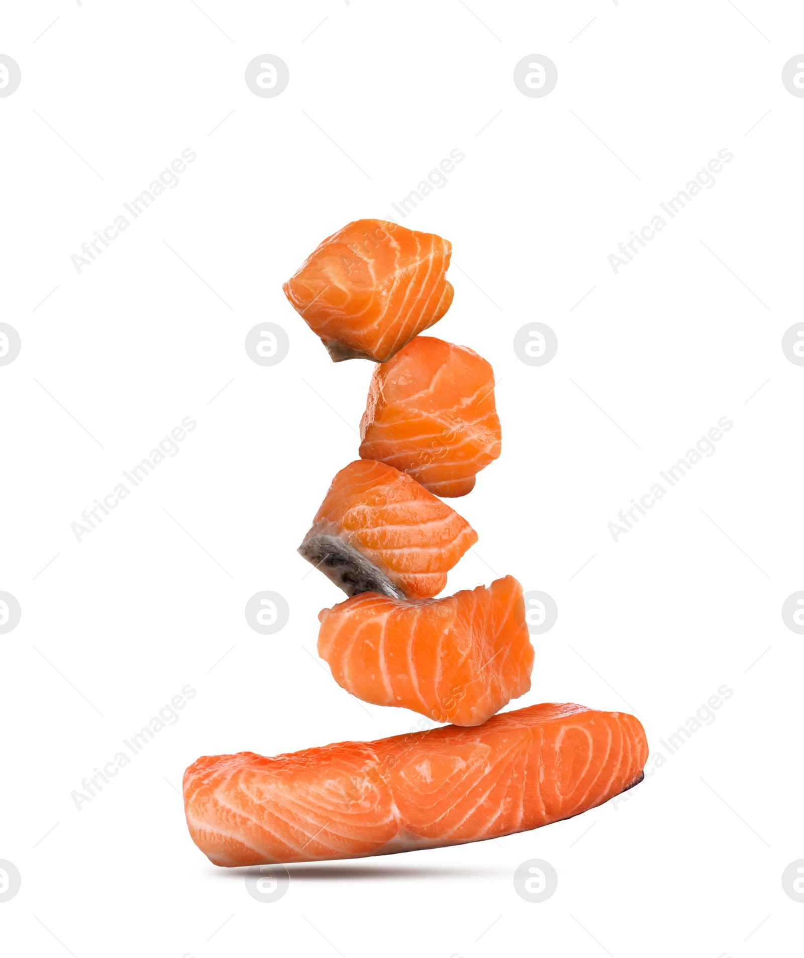 Image of Cut fresh salmon falling on white background