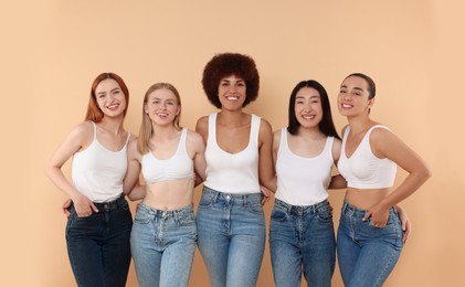 Photo of Group of beautiful young women on beige background