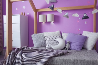 Photo of Comfortable bed in stylish child's room interior