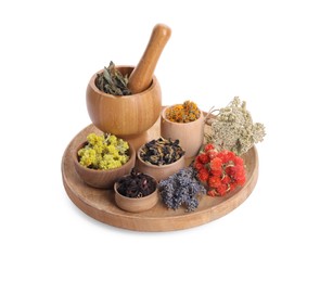 Mortar with pestle, many different dry herbs and flowers isolated on white