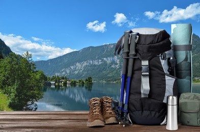 Image of Camping equipment for tourist on wooden surface and beautiful view of mountain landscape