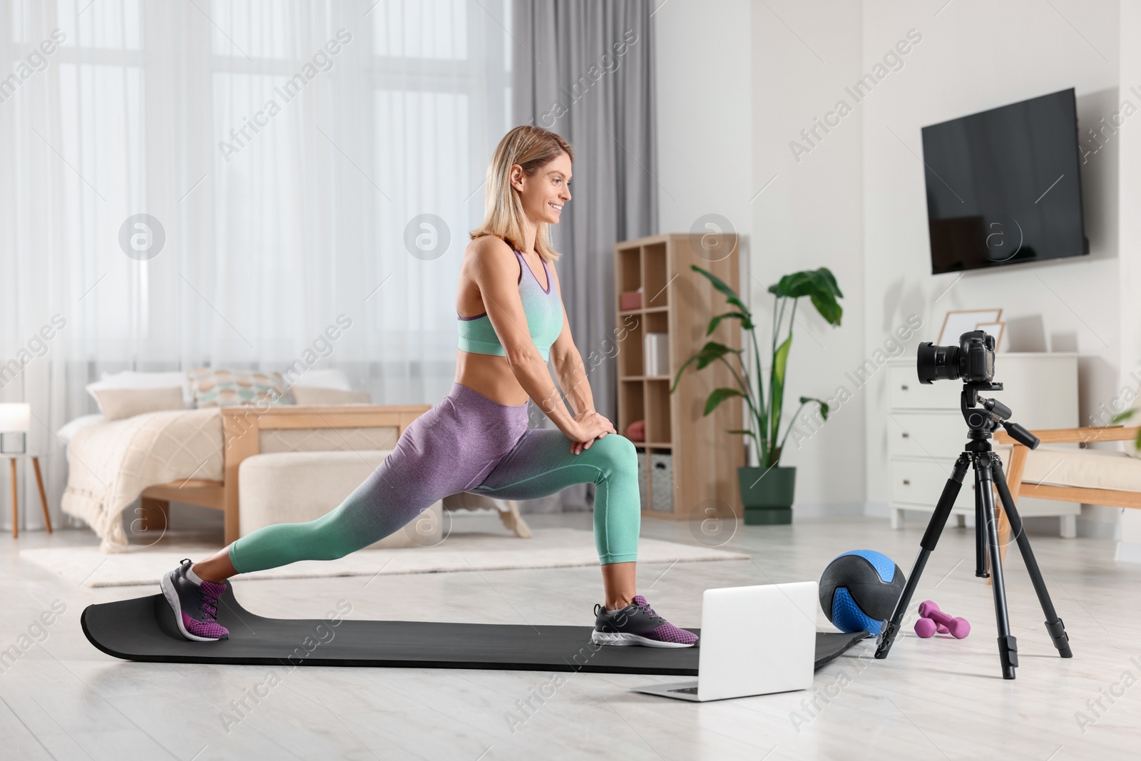 Photo of Fitness trainer recording online classes at home