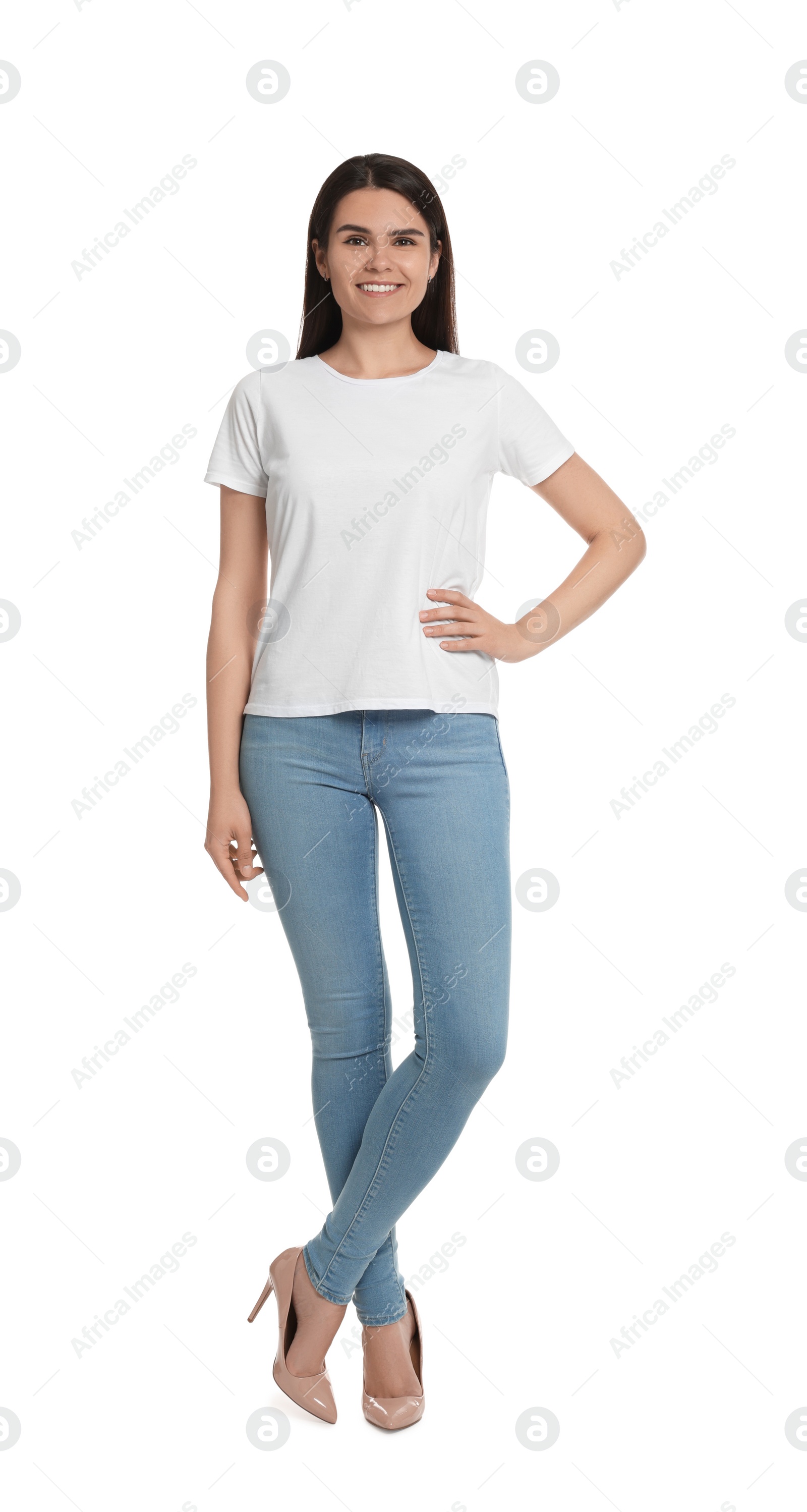Photo of Happy woman wearing stylish light blue jeans and high heels shoes on white background