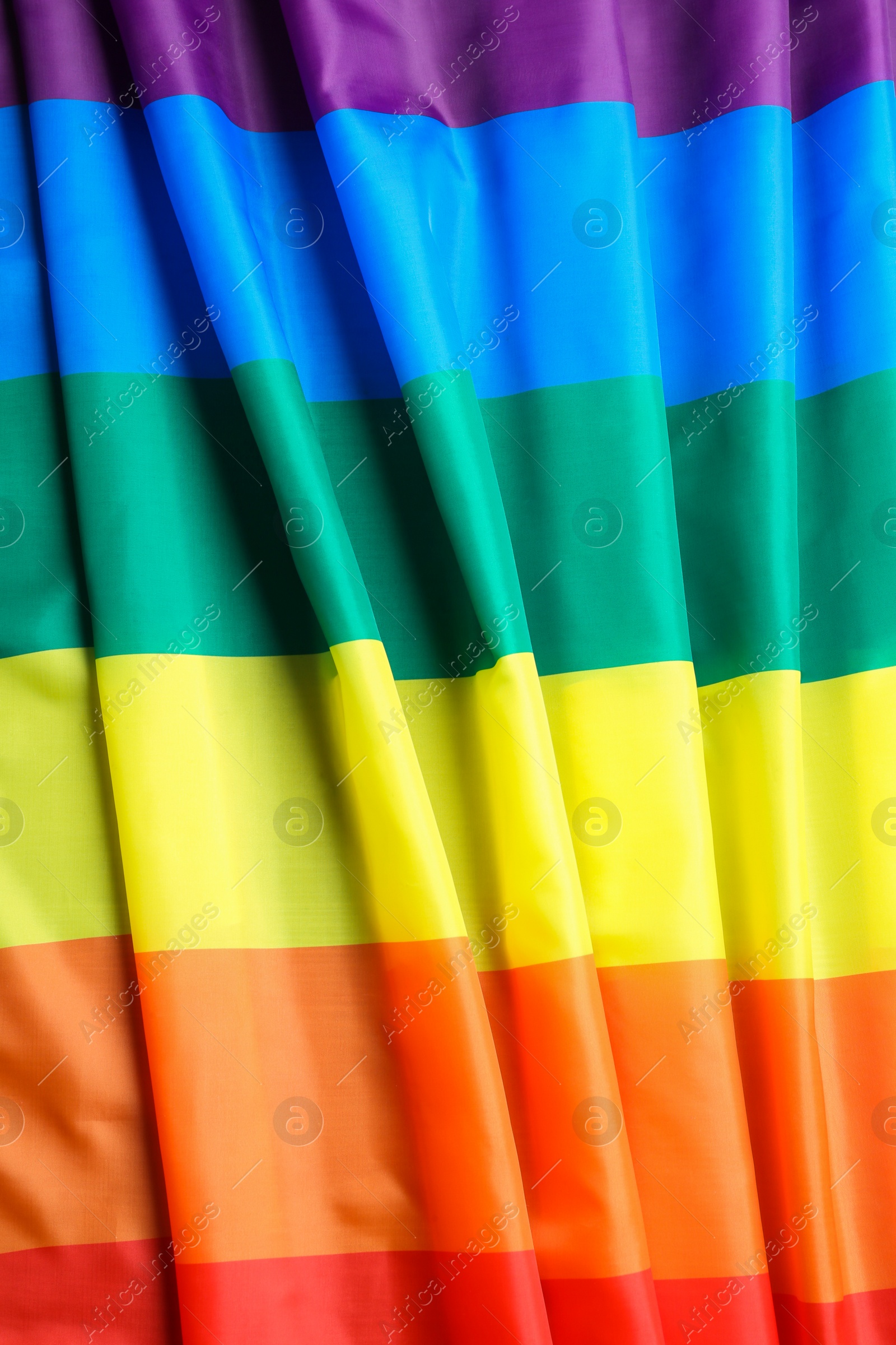 Photo of Bright rainbow gay flag as background. LGBT community