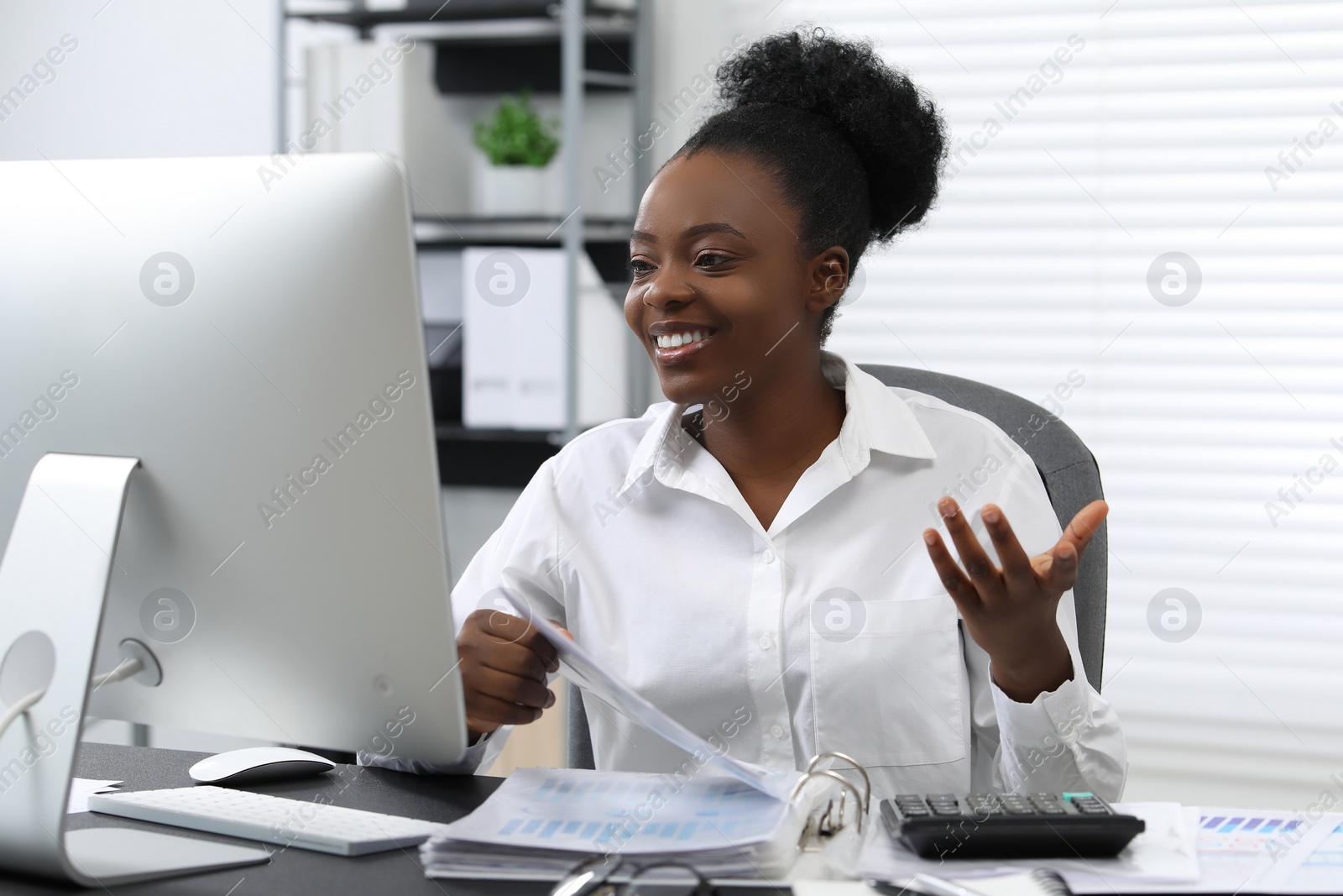 Photo of Professional accountant having video chat via computer at desk in office