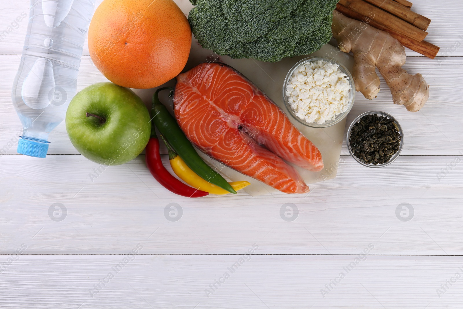 Photo of Metabolism. Different food products on white wooden table, flat lay with space for text