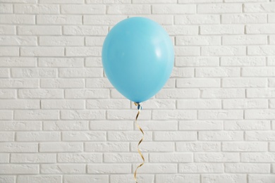 Bright balloon near brick wall. Celebration time