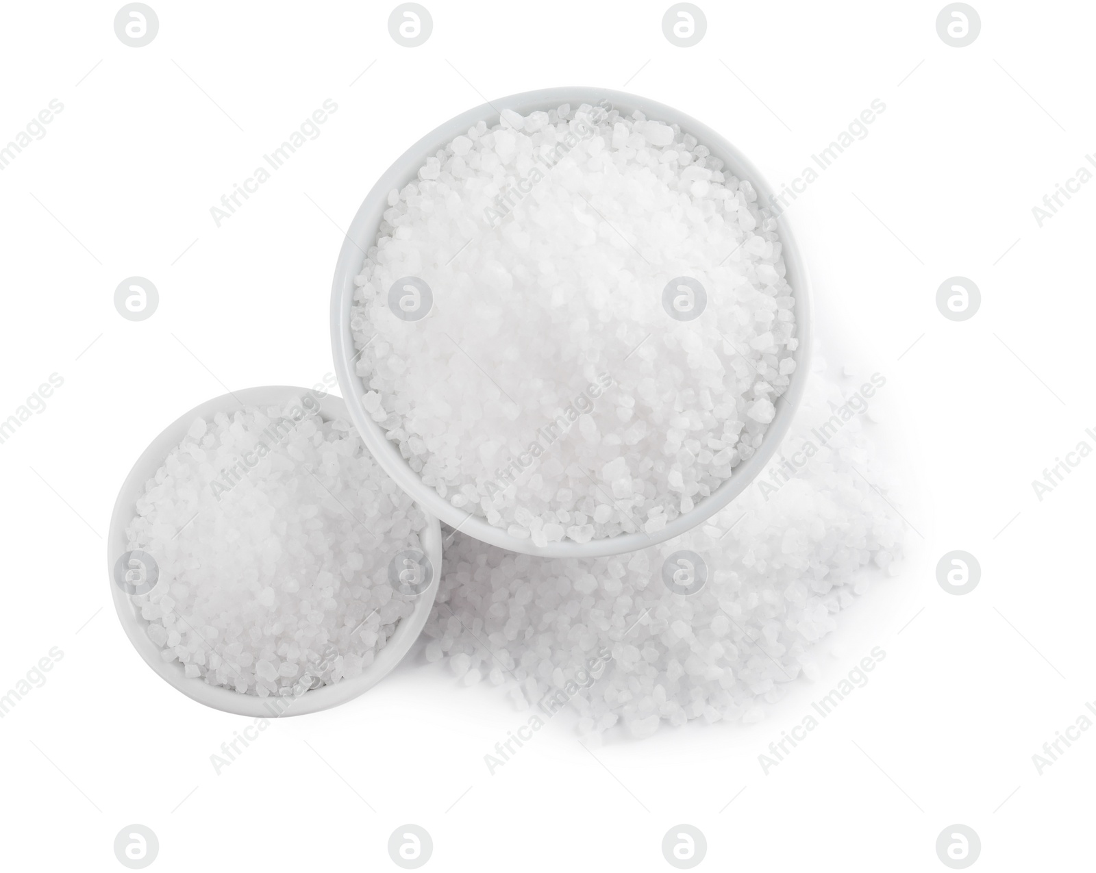 Photo of Ceramic bowls with natural sea salt isolated on white, top view