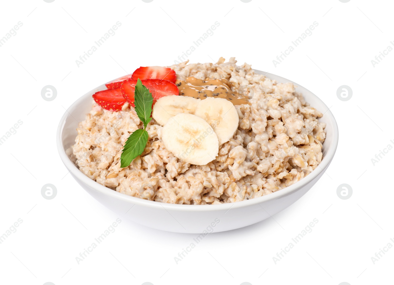 Photo of Tasty boiled oatmeal with strawberry, banana, peanut butter and chia seeds in bowl isolated on white