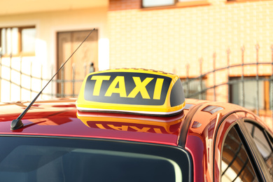 Photo of Roof light with word TAXI on car outdoors