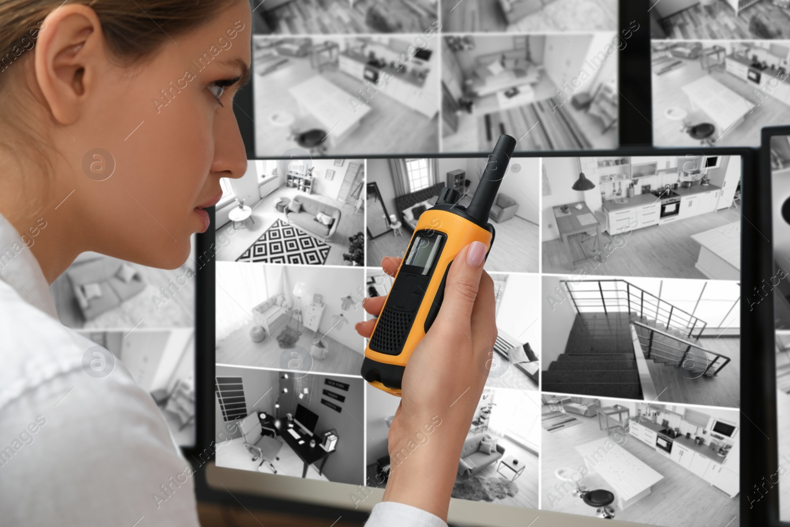 Photo of Security guard using portable transmitter at workplace, closeup