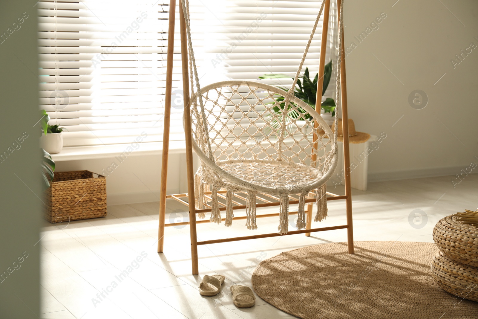 Photo of Comfortable hammock chair in stylish room. Interior design