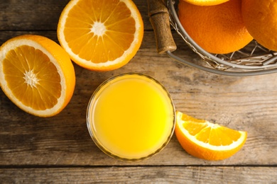 Photo of Flat lay composition with orange juice and fresh fruit on wooden background