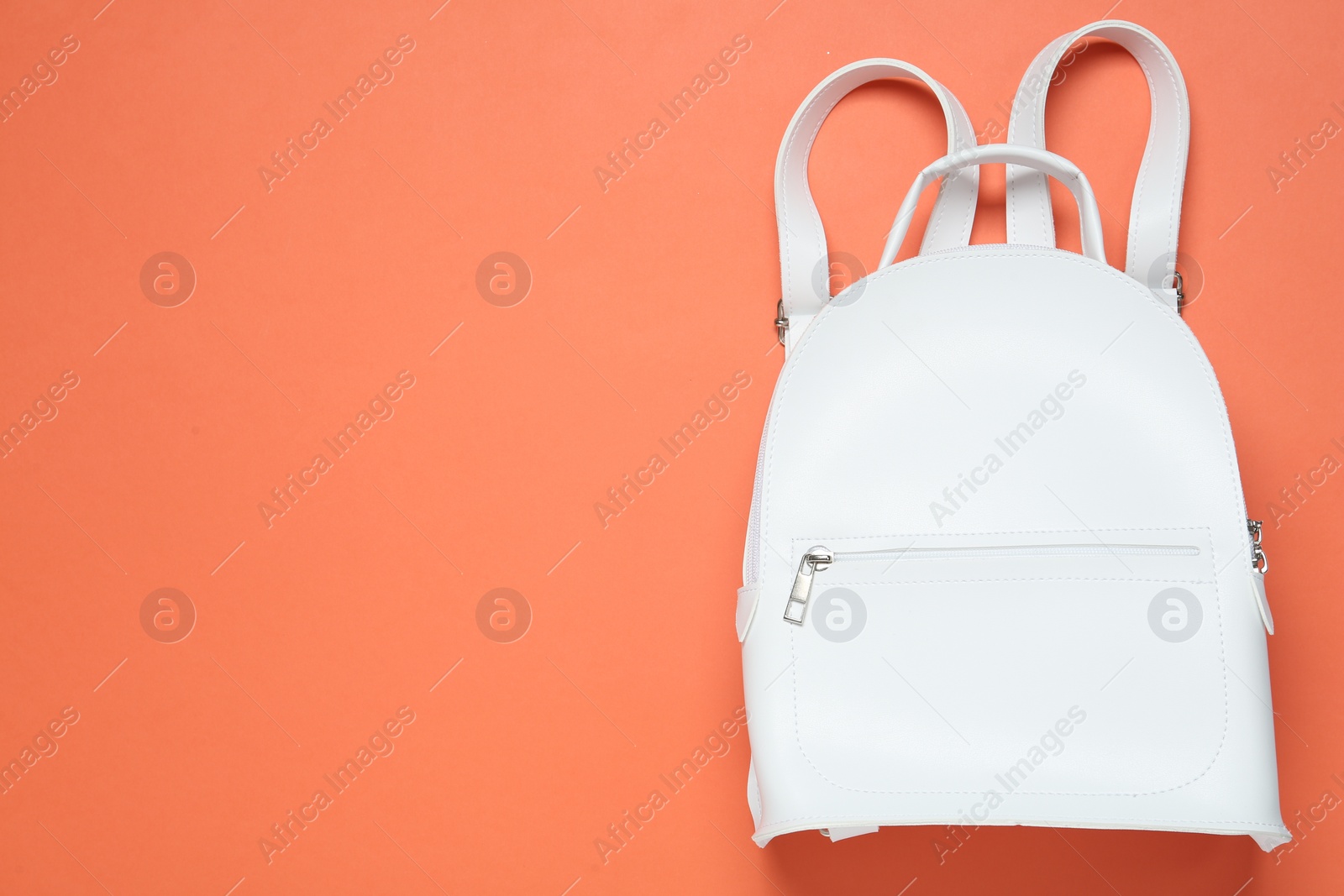 Photo of Stylish urban backpack on orange background, top view. Space for text