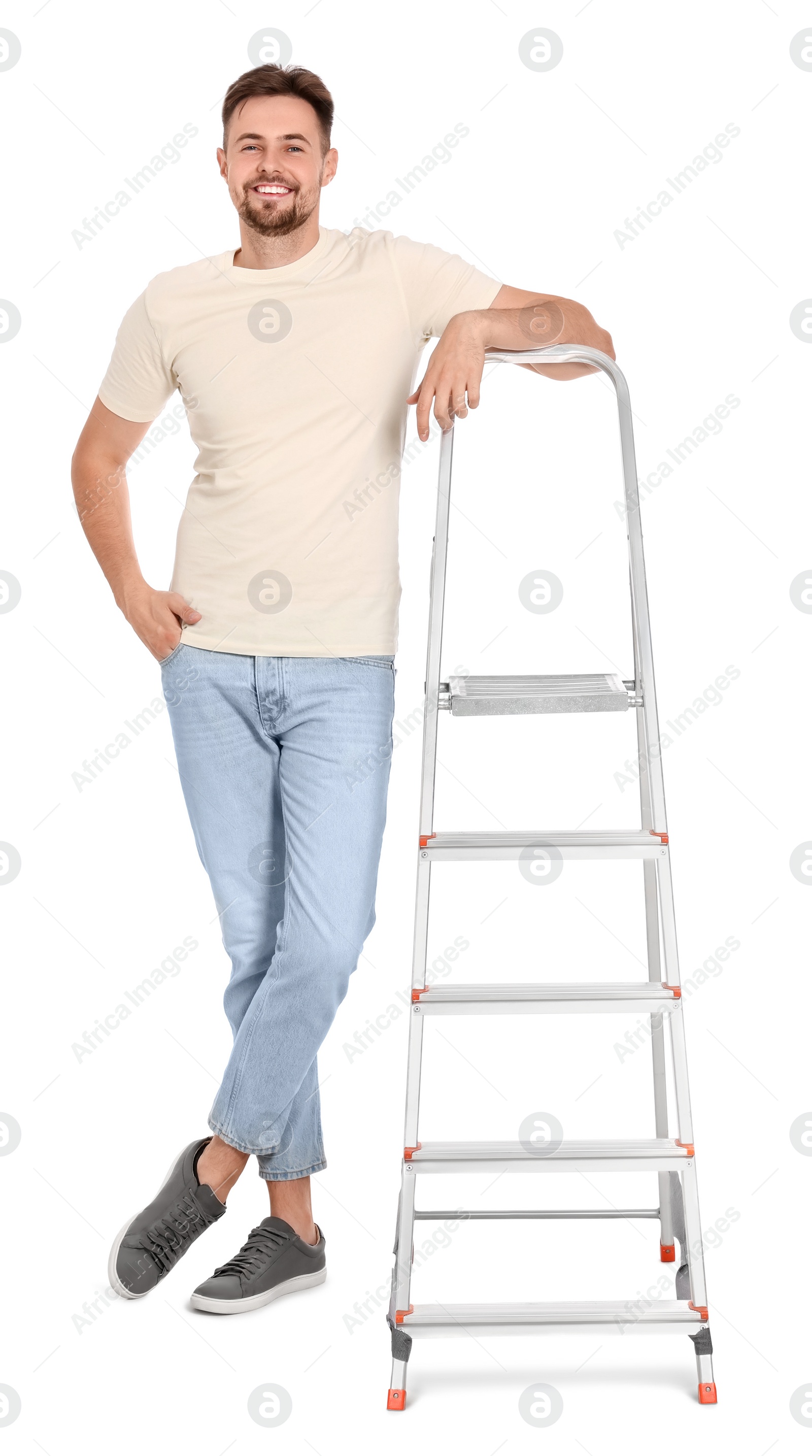 Photo of Young handsome man near metal ladder on white background