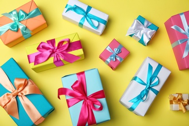 Photo of Flat lay composition with beautiful gift boxes on color background