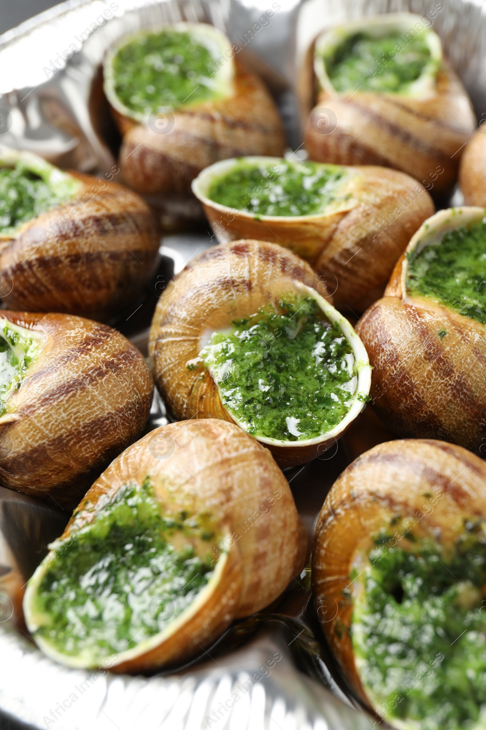 Photo of Delicious cooked snails on table, closeup view