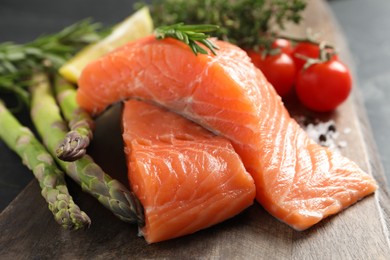 Fresh salmon and ingredients for marinade on wooden table, closeup