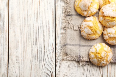 Photo of Delicious lemon cookies on wooden table, flat lay. Space for text