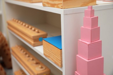 Photo of Shelving unit with different montessori toys indoors