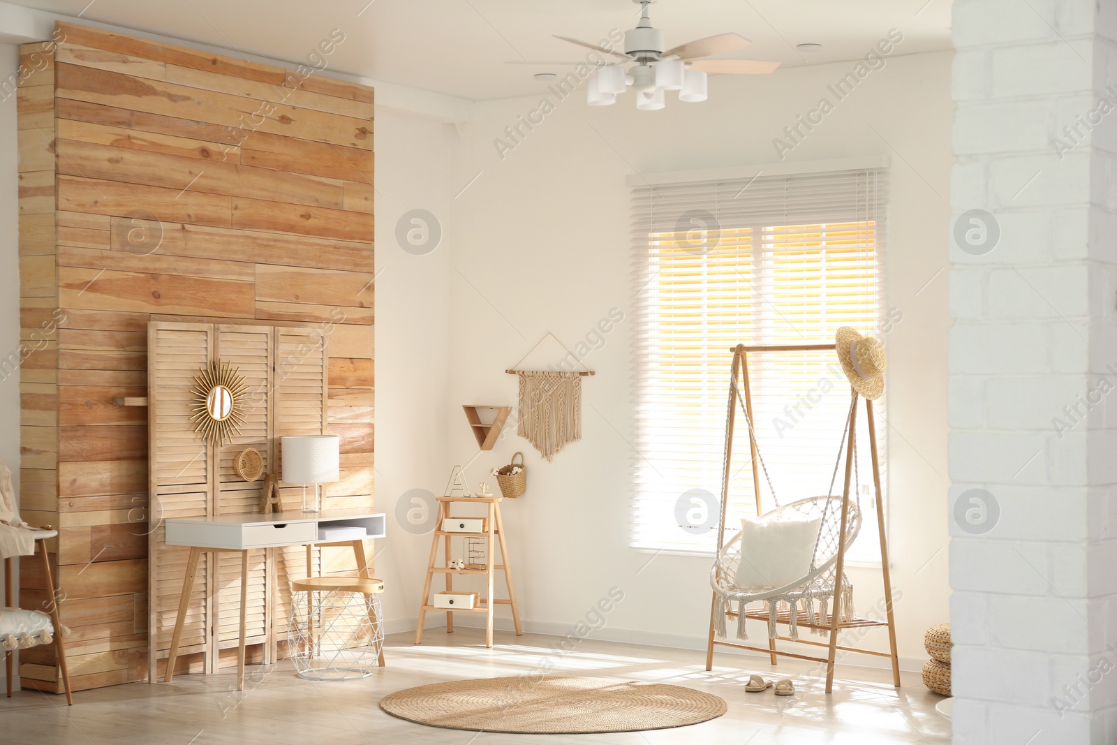 Photo of Comfortable hammock chair in stylish room. Home interior